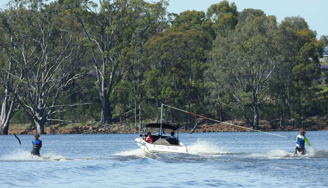 People skiing behind a boat People skiing behind a boat